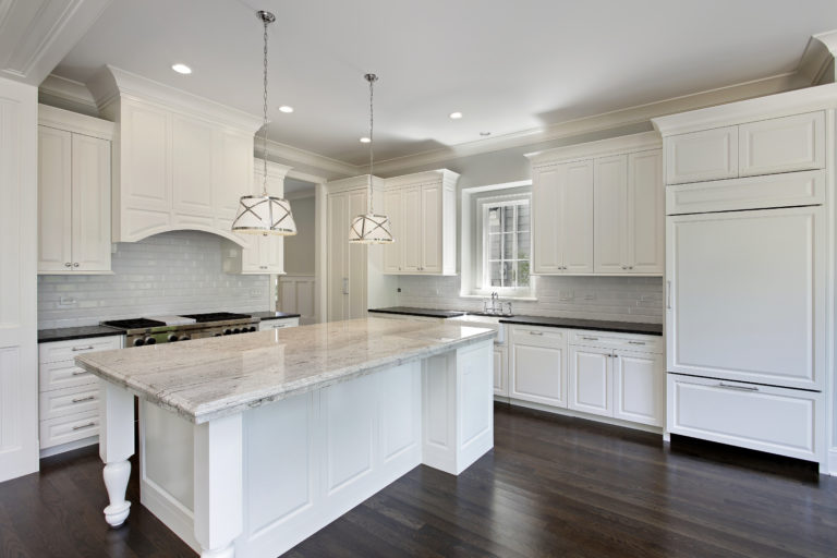 Kitchen remodeling in home with white cabinetry.