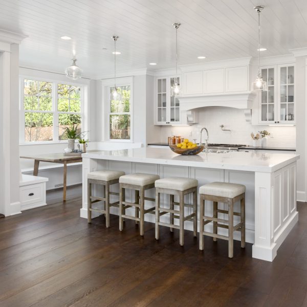 Beautiful White Kitchen. Features large island, eating nook, hardwood floors, and second sink.
