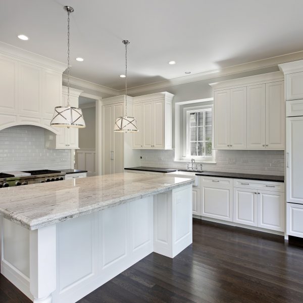 Kitchen-in-luxury-home-with-white-cabinetry.